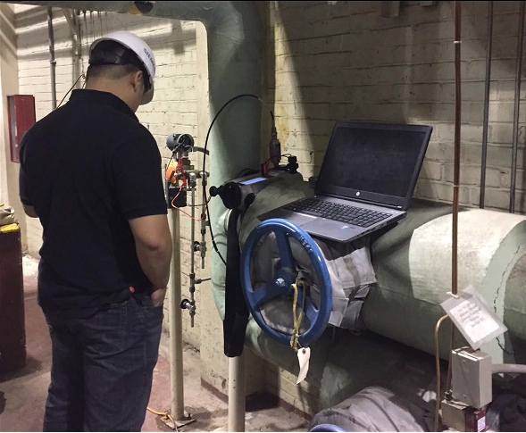 Picture of a man calibrating and maintaining digital controls and monitoring equipment